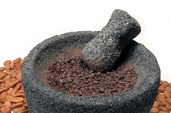 Cocoa,Beans,Being,Ground,In,Mortar,And,Pestle